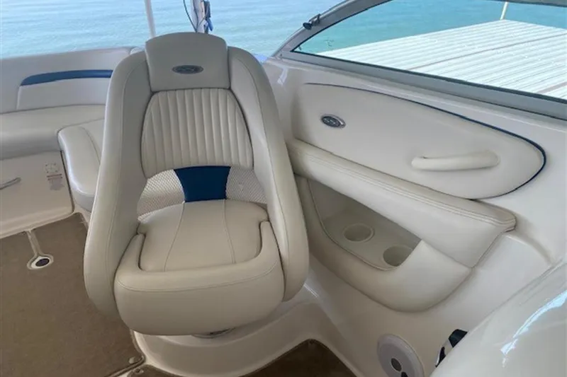 Slide: The Image of 2003 Chaparral 260 SSi boat interior with white leather seating and ocean view. - 23