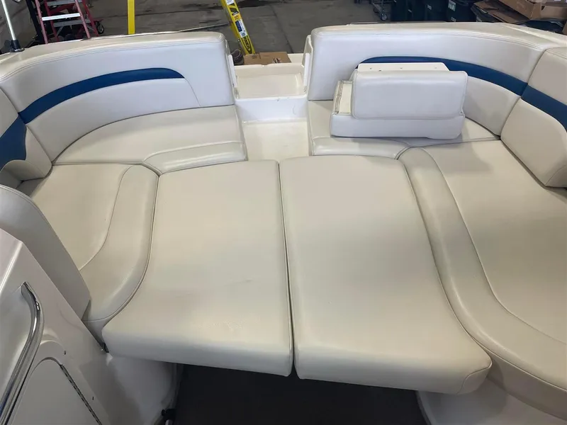 Slide: The Image of 2003 Chaparral 260 SSi boat interior with white and blue cushioned seating. - 3