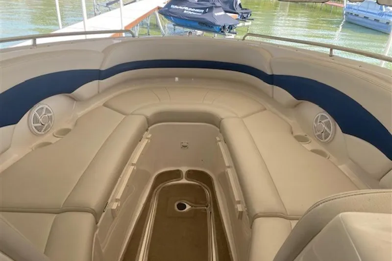 Slide: The Image of 2003 Chaparral 260 SSi boat interior with beige seating and blue accents. - 5