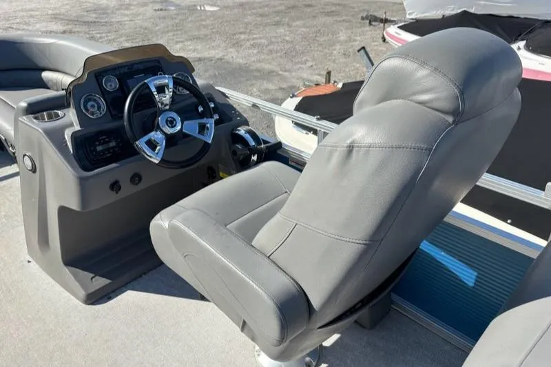 Slide: The Image of 2020 Tahoe Pontoon GT Quad Lounger 23' helm with plush captain's chair and steering wheel. - 4