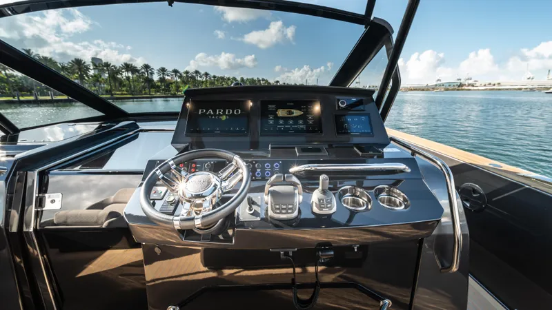 Slide: The Image of 2023 Pardo Yachts P50 helm with modern controls and scenic waterfront view. - 26