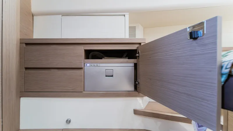 Slide: The Image of 2023 Pardo Yachts P50 interior with open wooden cabinet and built-in appliance. - 40