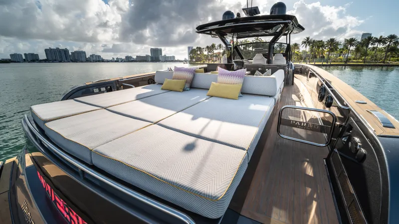 Slide: The Image of 2023 Pardo Yachts P50 luxury yacht with sunbathing deck, docked by palm-lined waterfront. - 16