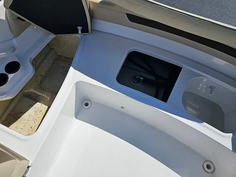 Slide: The Image of 2020 Hurricane SunDeck Sport 185 OB boat interior with storage compartments and cup holders. - 15