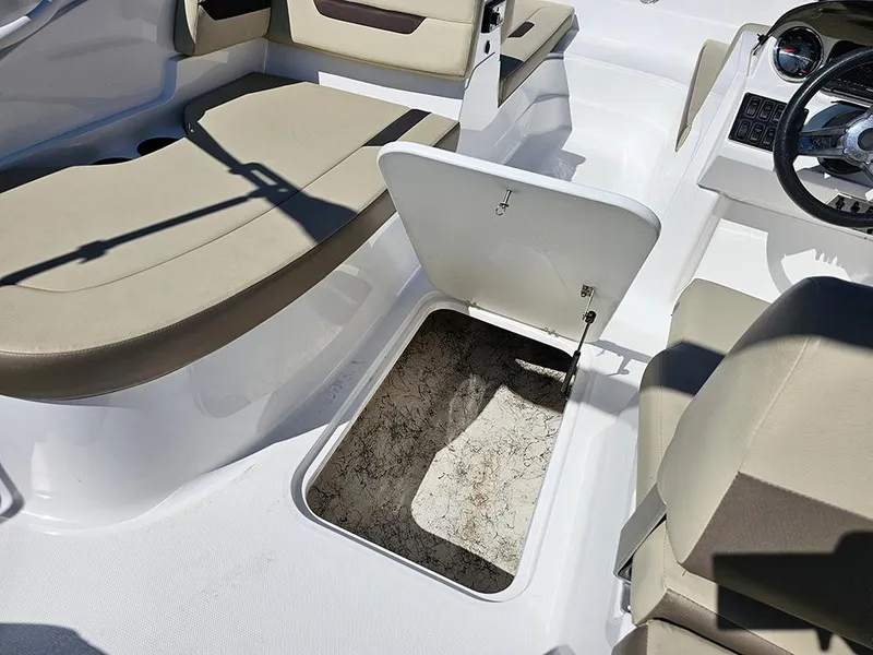Slide: The Image of 2020 Hurricane SunDeck Sport 185 OB interior with open storage compartment. - 18