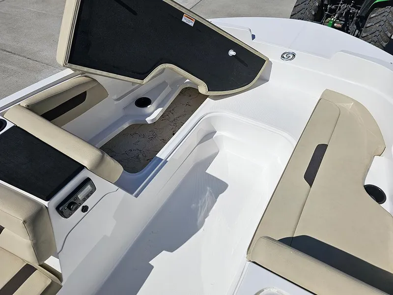 Slide: The Image of 2020 Hurricane SunDeck Sport 185 OB interior with open storage compartment and beige seating. - 20