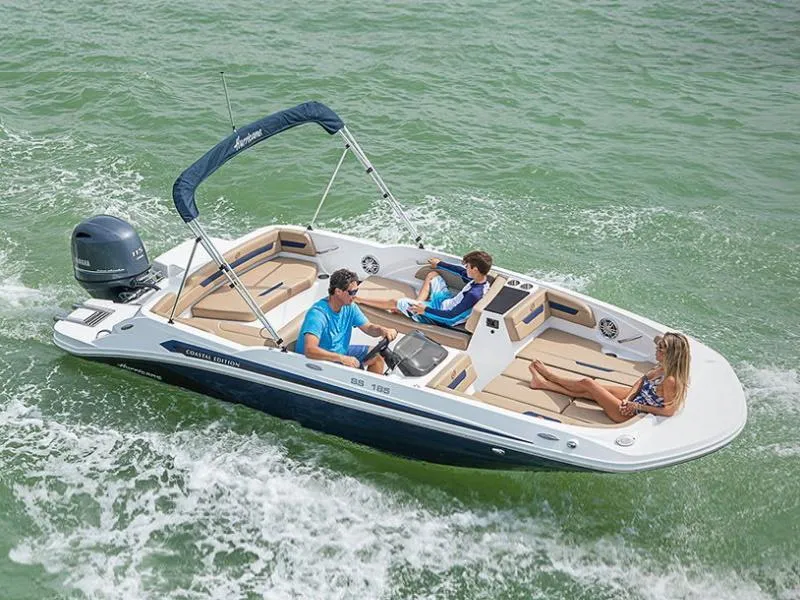 Slide: The Image of 2020 Hurricane SunDeck Sport 185 OB boat cruising with three passengers on a sunny day. - 25