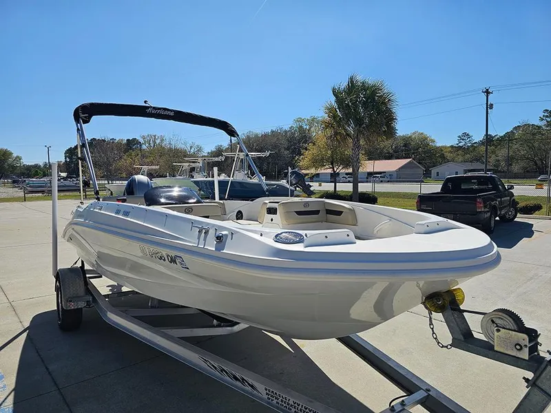 Slide: The Image of 2020 Hurricane SunDeck Sport 185 OB boat on trailer, parked outdoors under clear sky. - 4