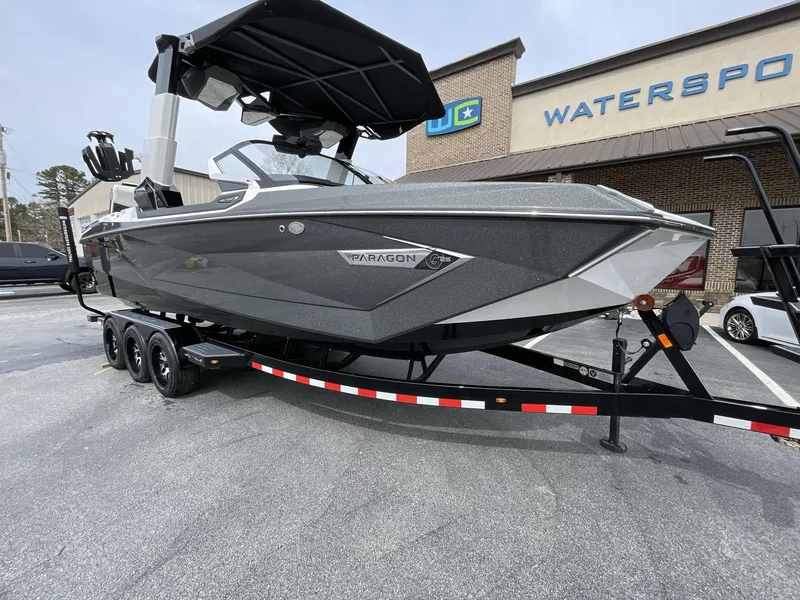 Slide: The Image of 2023 Nautique Super Air Nautique G25 Paragon boat on trailer outside dealership. - 11