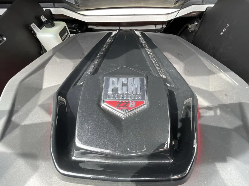 Slide: The Image of Engine cover of 2023 Nautique Super Air Nautique G25 Paragon with PCM branding. - 14