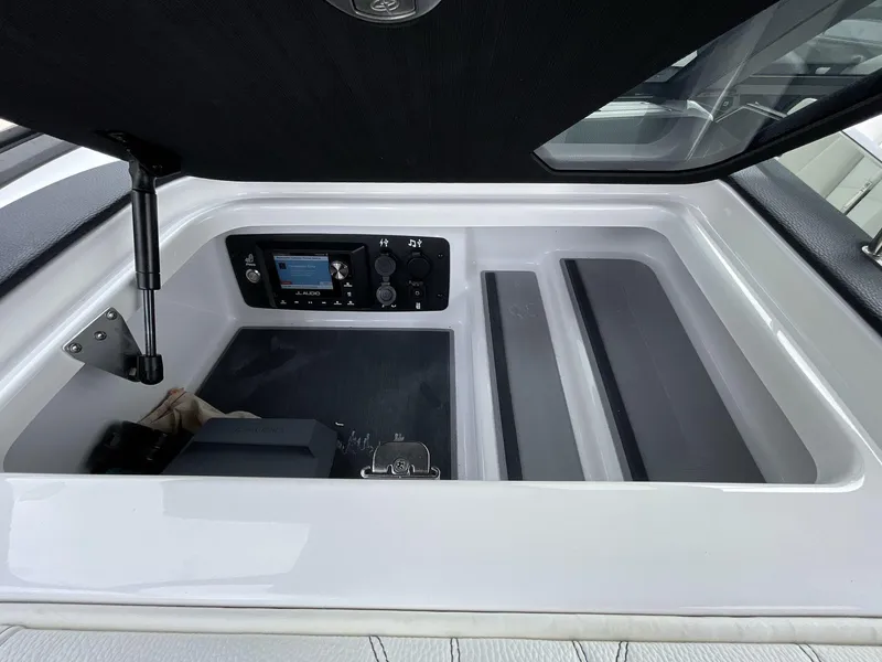 Slide: The Image of 2023 Nautique Super Air Nautique G25 Paragon storage compartment with control panel. - 20