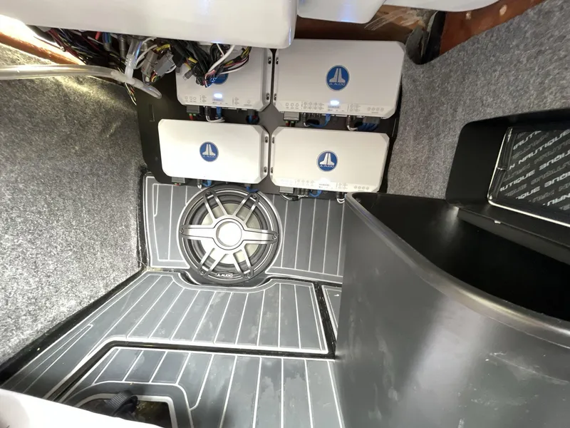 Slide: The Image of 2023 Nautique Super Air Nautique G25 Paragon audio system with subwoofer and amplifiers. - 24