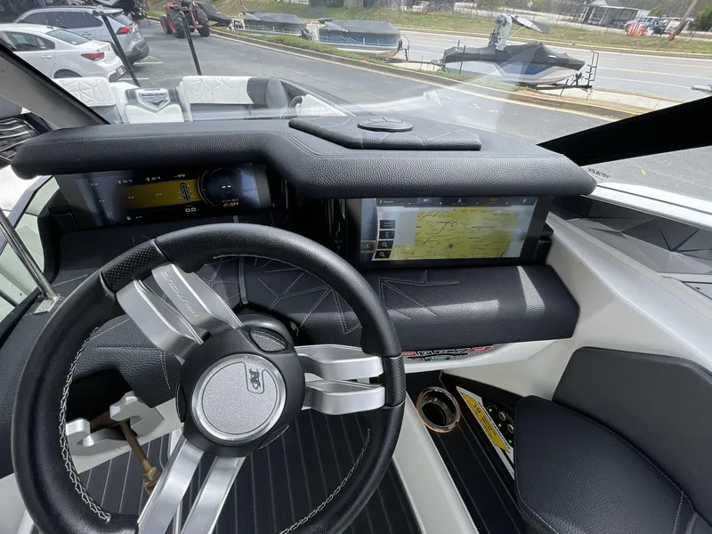 Slide: The Image of 2023 Nautique Super Air Nautique G25 Paragon dashboard with advanced controls and sleek steering wheel. - 28