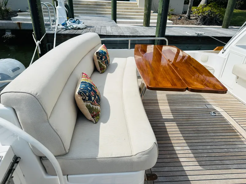 Slide: The Image of Luxurious seating area on 2014 Grand Banks 46 Eastbay SX yacht with wooden table. - 12