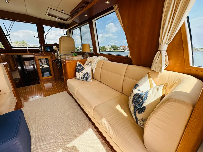 Slide: The Image of Luxurious interior of 2014 Grand Banks 46 Eastbay SX yacht with beige seating and nautical decor. - 17