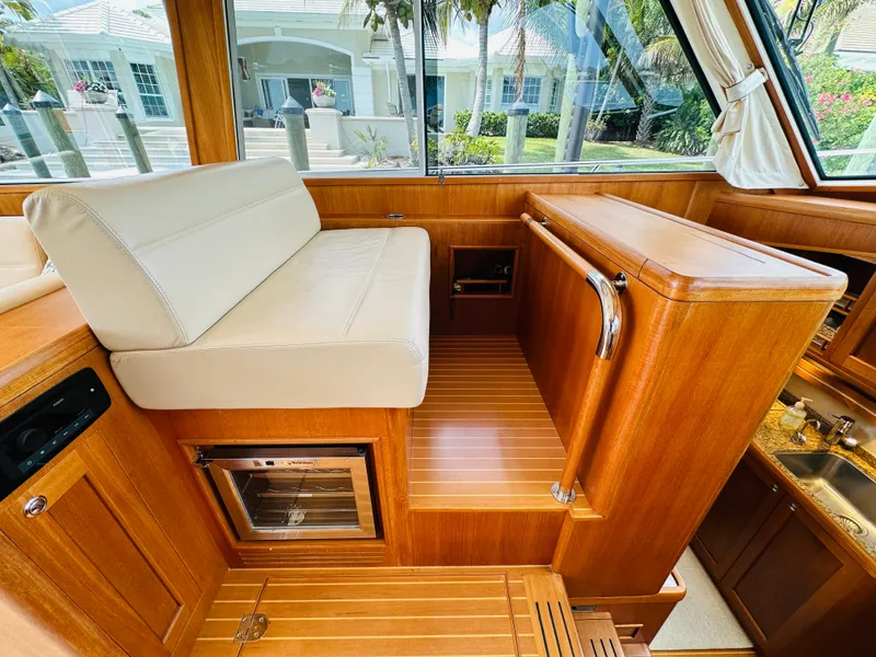Slide: The Image of Interior of 2014 Grand Banks 46 Eastbay SX yacht with wooden finish and seating area. - 23