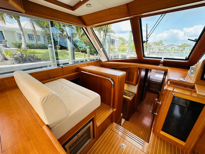 Slide: The Image of 2014 Grand Banks 46 Eastbay SX interior with wood finish and large windows. - 26