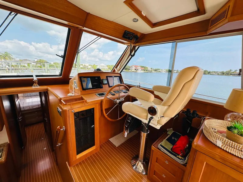 Slide: The Image of Helm of 2014 Grand Banks 46 Eastbay SX with leather chair and navigation equipment. - 27