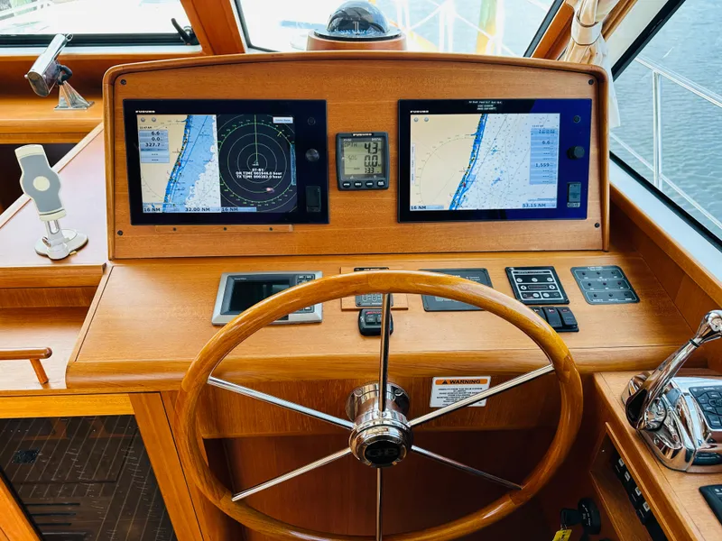 Slide: The Image of Steering wheel and navigation screens on 2014 Grand Banks 46 Eastbay SX yacht. - 28