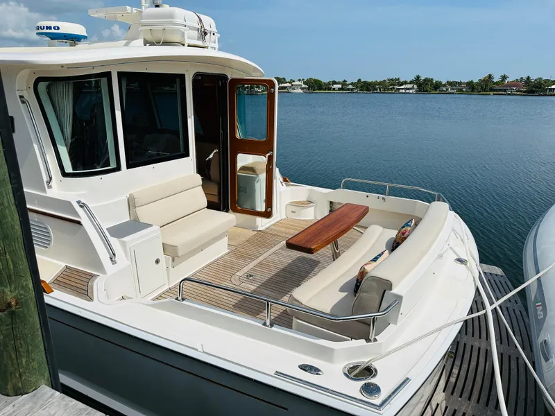 Slide: The Image of 2014 Grand Banks 46 Eastbay SX yacht with spacious deck and seating area. - 3