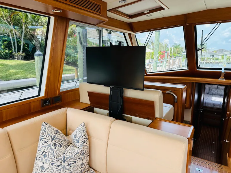 Slide: The Image of Luxurious interior of 2014 Grand Banks 46 Eastbay SX yacht with plush seating and large windows. - 33