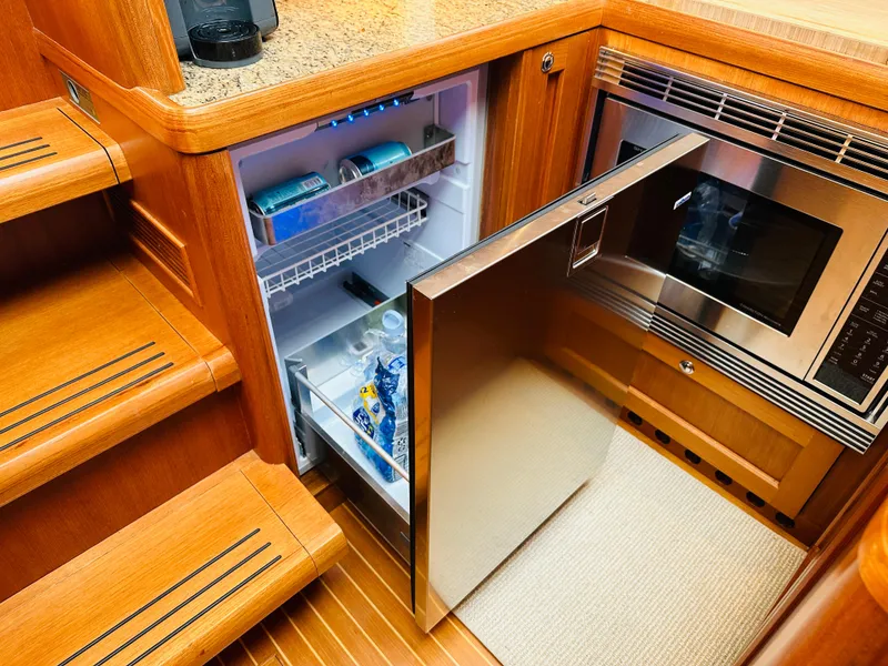 Slide: The Image of 2014 Grand Banks 46 Eastbay SX yacht kitchen with open fridge and microwave. - 37