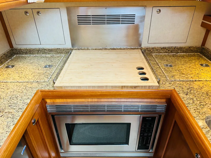 Slide: The Image of 2014 Grand Banks 46 Eastbay SX galley with granite countertops and built-in microwave. - 39