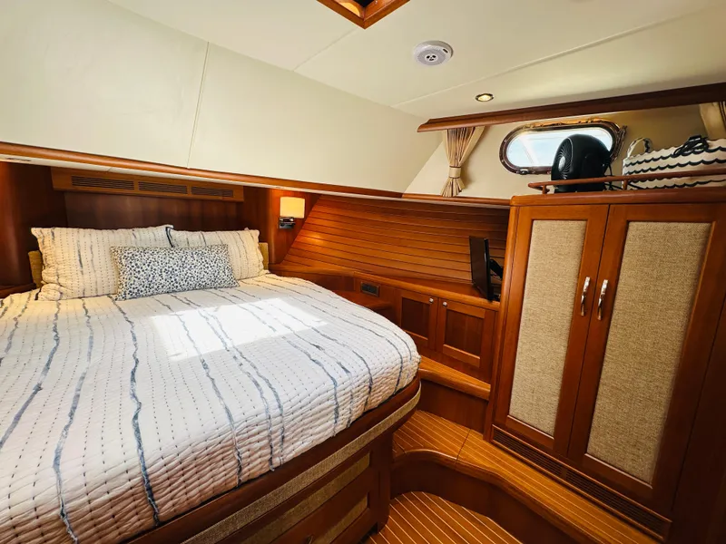 Slide: The Image of Luxurious cabin interior of 2014 Grand Banks 46 Eastbay SX yacht with cozy bed and wooden finishes. - 43