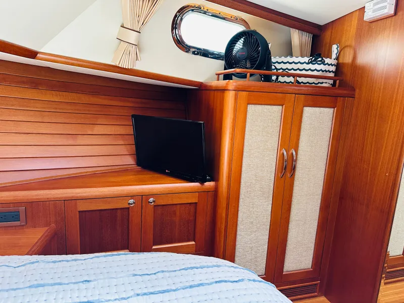 Slide: The Image of Luxurious cabin interior of 2014 Grand Banks 46 Eastbay SX with wood paneling and modern amenities. - 44