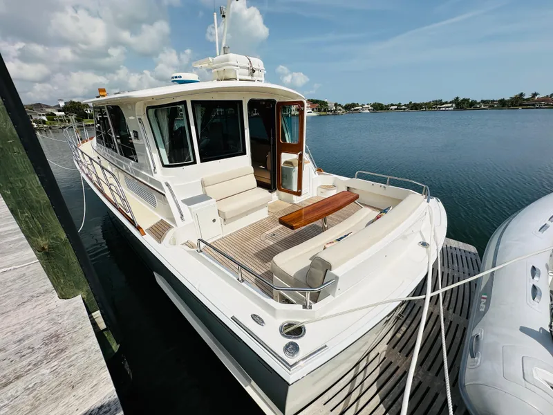 Slide: The Image of 2014 Grand Banks 46 Eastbay SX yacht docked by serene waters. - 5