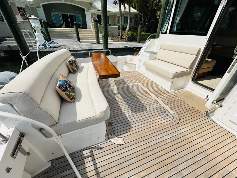 Slide: The Image of 2014 Grand Banks 46 Eastbay SX yacht with spacious deck seating and wooden table. - 8