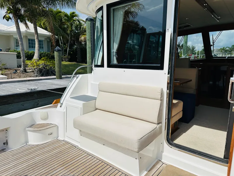 Slide: The Image of 2014 Grand Banks 46 Eastbay SX yacht with outdoor seating and teak deck. - 9