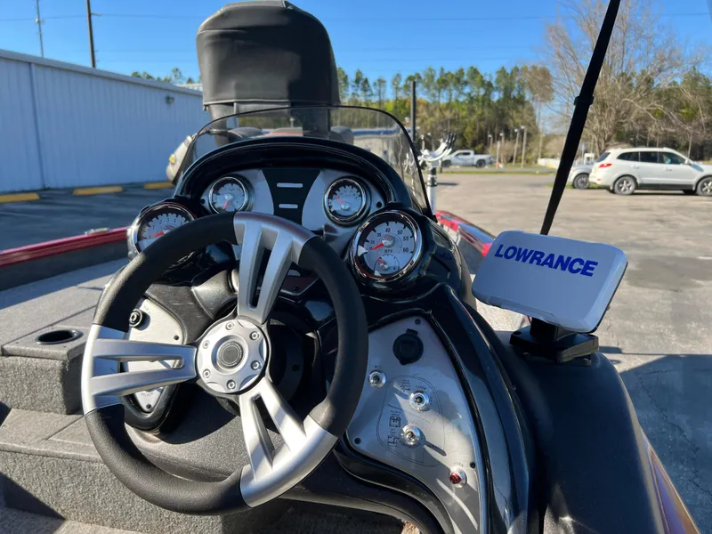 Slide: The Image of Bass Tracker Pro Team 175 dashboard with Lowrance system, 2022 model, in a parking lot. - 14