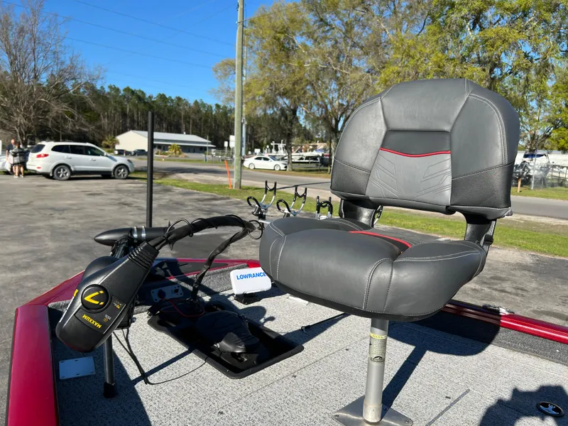 Slide: The Image of 2022 Bass Tracker Pro Team 175 boat seat and controls in a sunny outdoor setting. - 21