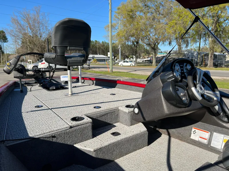 Slide: The Image of 2022 Bass Tracker Pro Team 175 boat interior with steering wheel and seating. - 22
