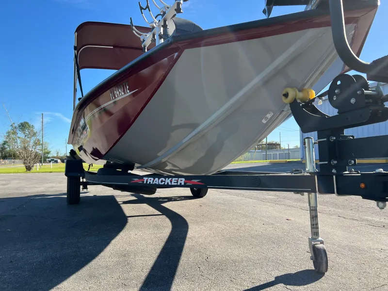 Slide: The Image of 2022 Bass Tracker Pro Team 175 boat on trailer, parked outdoors under clear sky. - 23