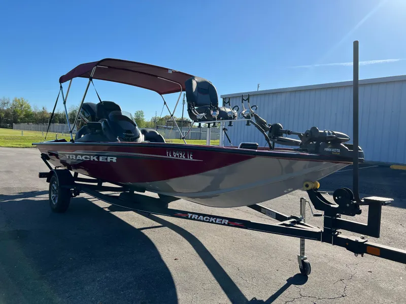 Slide: The Image of 2022 Bass Tracker Pro Team 175 boat on trailer, parked outdoors under clear sky. - 4