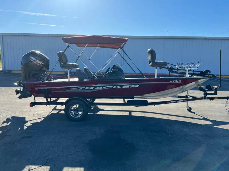 Slide: The Image of 2022 Bass Tracker Pro Team 175 boat with canopy and trailer in a parking lot. - 5