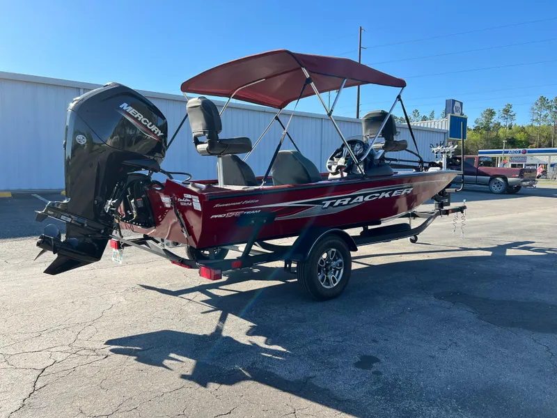 Slide: The Image of 2022 Bass Tracker Pro Team 175 boat with Mercury engine, parked outdoors. - 6