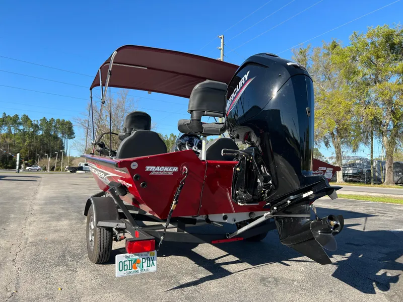 Slide: The Image of 2022 Bass Tracker Pro Team 175 boat with Mercury engine, parked outdoors. - 9