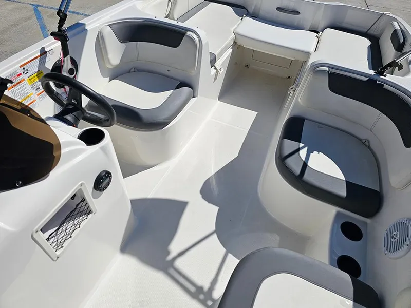 Slide: The Image of 2021 Bayliner Element E18 boat interior with seating and steering wheel. - 10