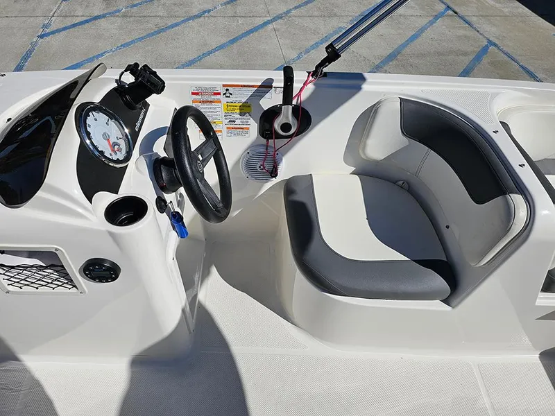 Slide: The Image of 2021 Bayliner Element E18 boat cockpit with steering wheel and seating. - 11