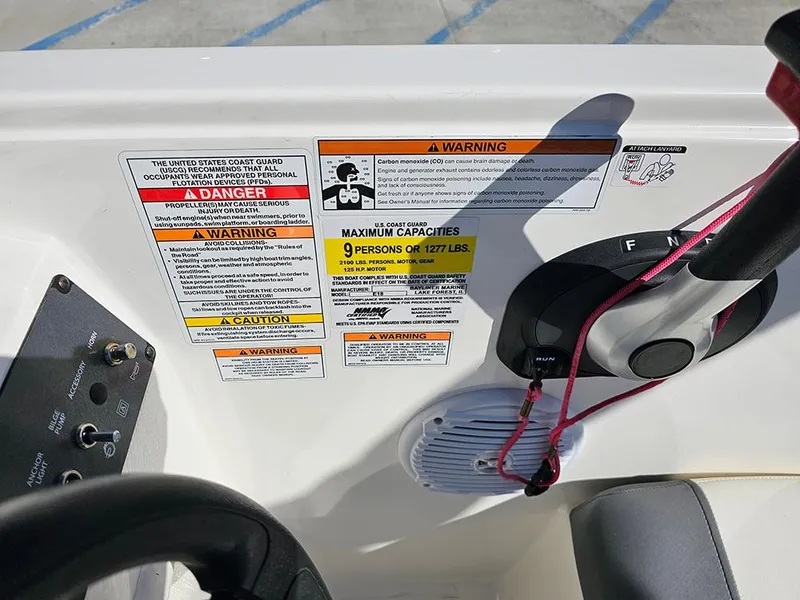 Slide: The Image of Control panel of 2021 Bayliner Element E18 with safety warnings and capacity details. - 12