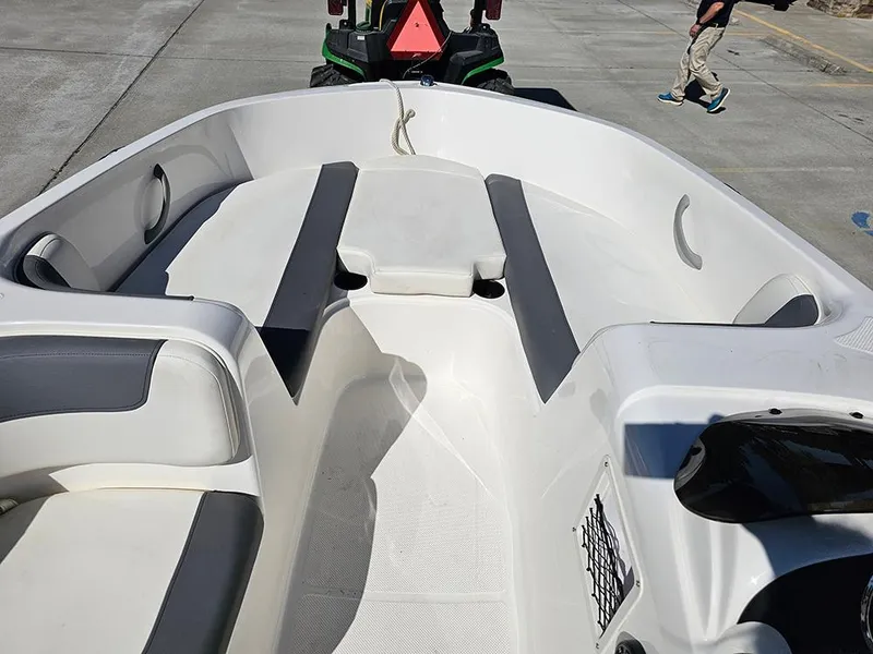 Slide: The Image of 2021 Bayliner Element E18 boat interior with seating and storage compartments. - 15