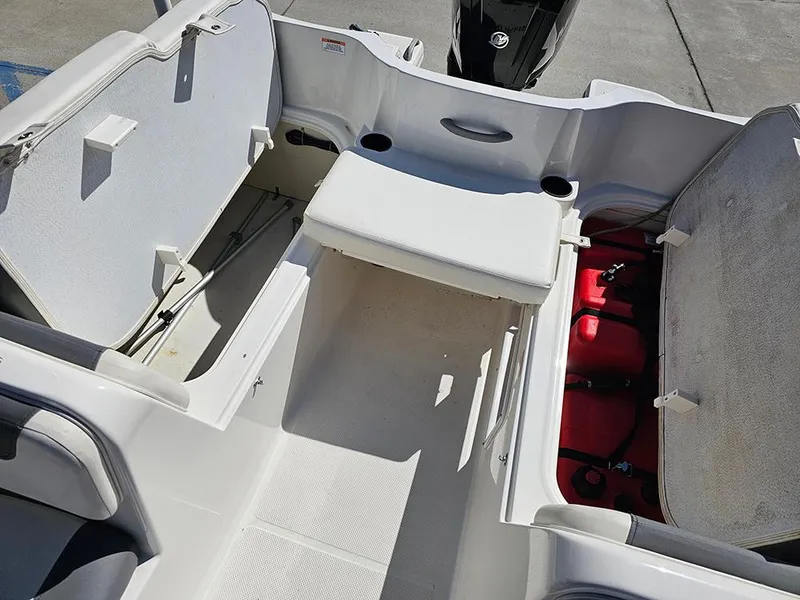Slide: The Image of 2021 Bayliner Element E18 boat interior with open storage compartments and seating. - 16