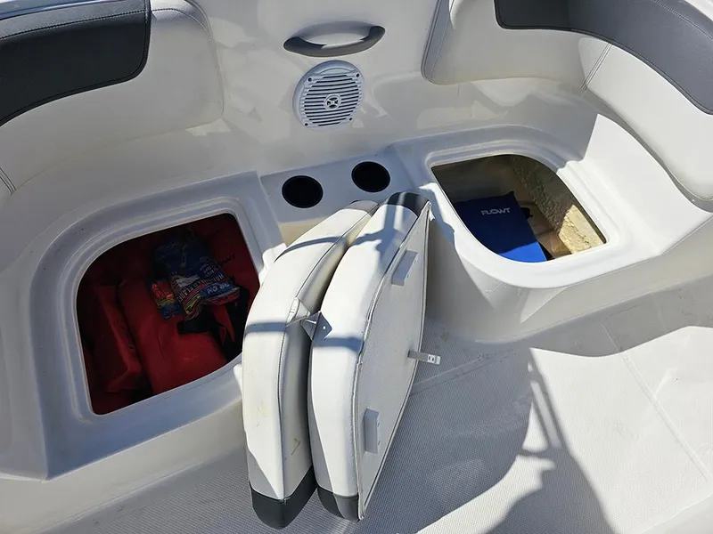 Slide: The Image of 2021 Bayliner Element E18 boat interior with storage compartments and cup holders. - 17