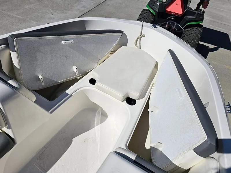 Slide: The Image of 2021 Bayliner Element E18 boat interior with open storage compartments. - 19