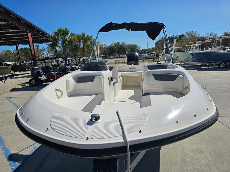 Slide: The Image of 2021 Bayliner Element E18 boat with canopy, docked outdoors on a sunny day. - 3