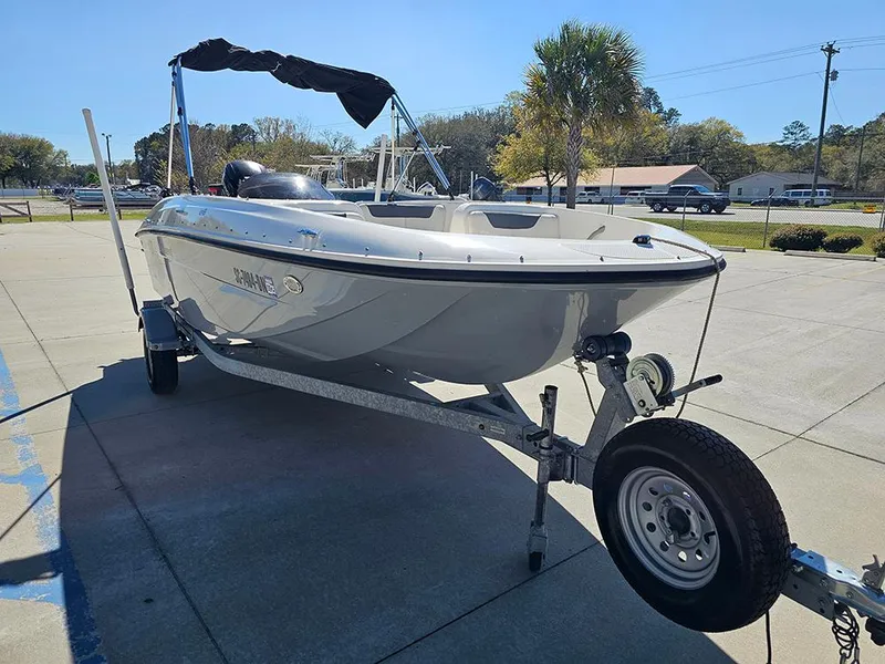 Slide: The Image of 2021 Bayliner Element E18 boat on trailer in sunny outdoor setting. - 4