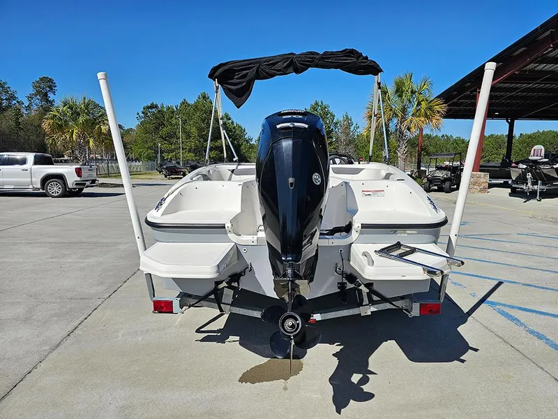 Slide: The Image of 2021 Bayliner Element E18 boat with outboard motor, parked outdoors on a sunny day. - 7